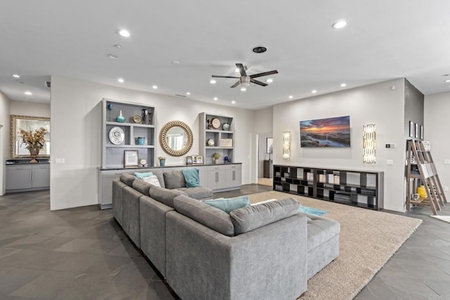 living room featuring built in shelves and concrete flooring