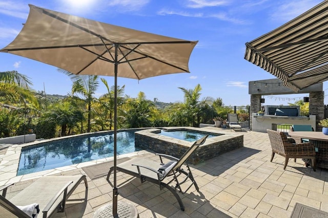 view of pool with an in ground hot tub, exterior bar, and a patio