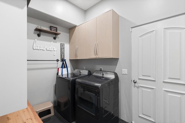 washroom featuring cabinets and independent washer and dryer