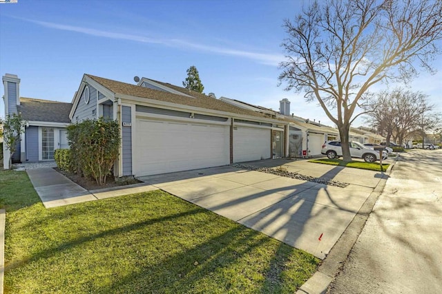 view of front of home with a garage and a front yard