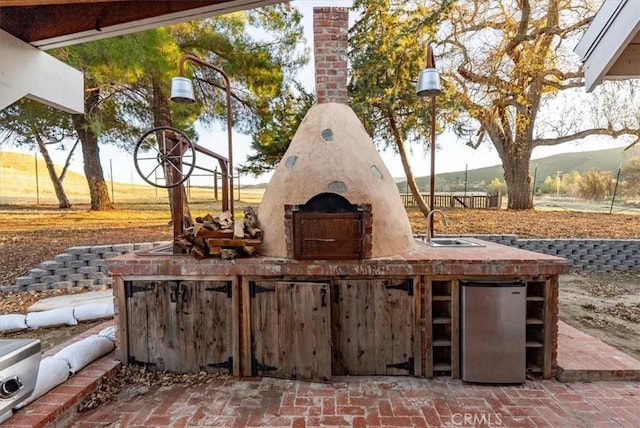 view of patio / terrace with a mountain view and sink