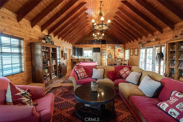 living room featuring an inviting chandelier, french doors, beamed ceiling, and wood walls