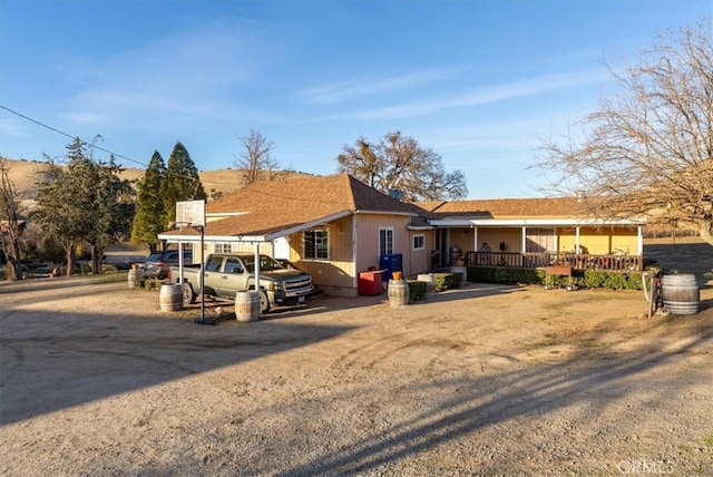 view of front of home featuring a carport and a porch