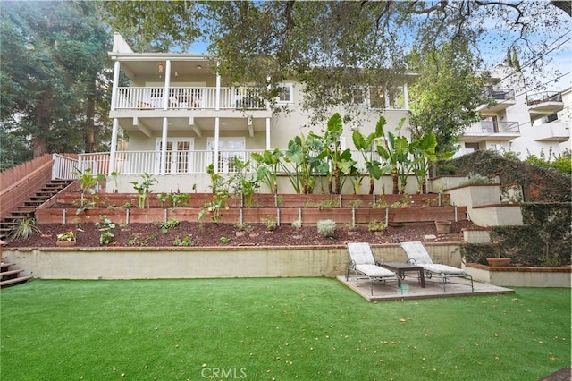 view of yard with a balcony and a patio area