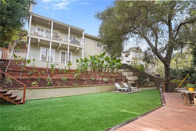 view of yard with a balcony