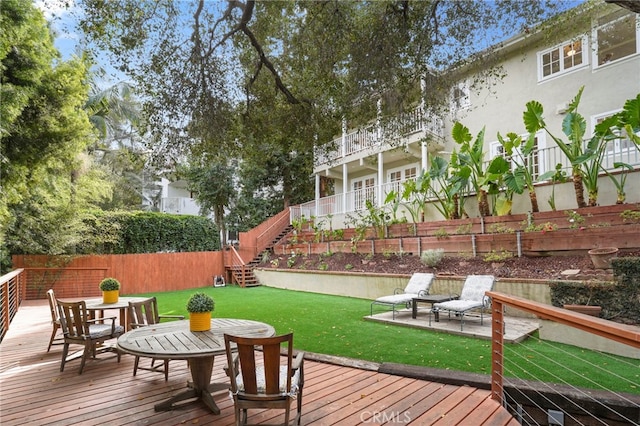 deck featuring a patio and a yard