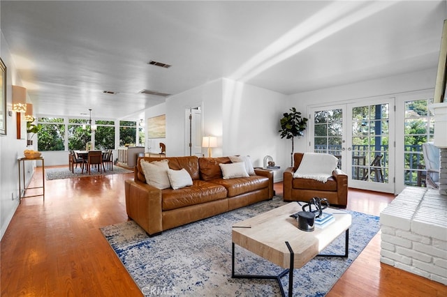 living room featuring light hardwood / wood-style floors and french doors