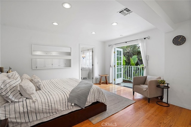 bedroom featuring access to exterior and wood-type flooring