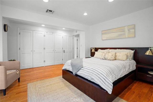 bedroom with wood-type flooring and a closet