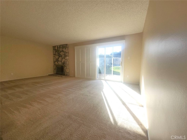 unfurnished living room featuring a textured ceiling and carpet flooring