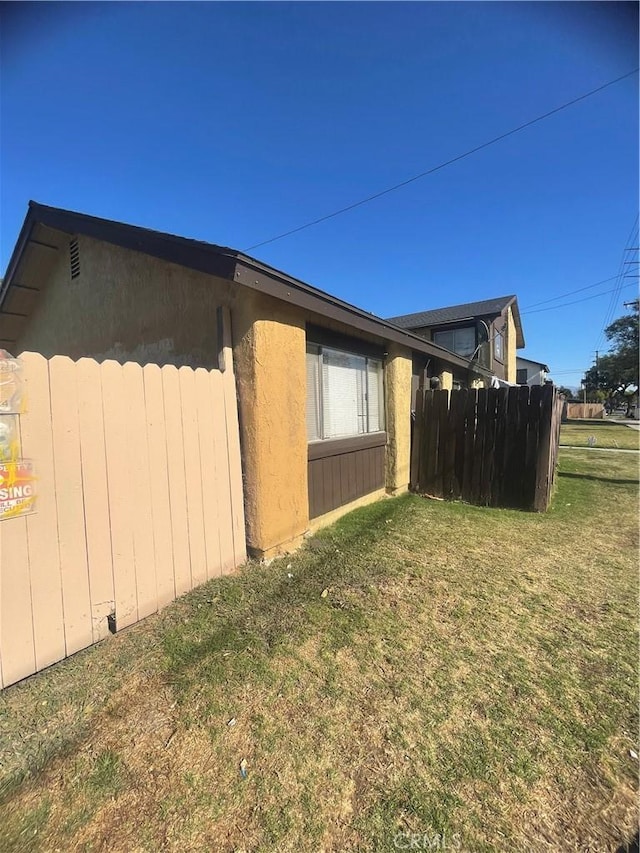 view of property exterior with a yard