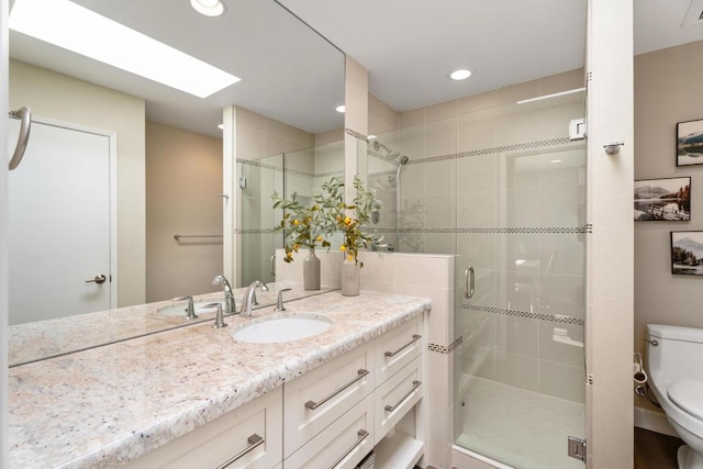 bathroom with vanity, toilet, and walk in shower