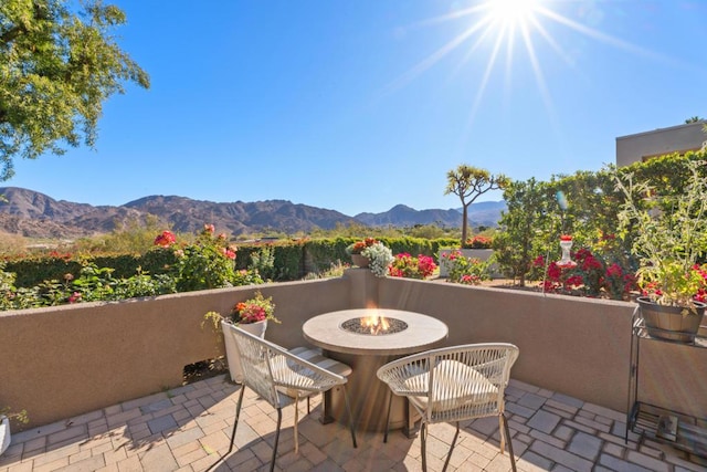 view of patio / terrace featuring a mountain view and a fire pit