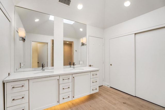 bathroom with vanity and hardwood / wood-style floors