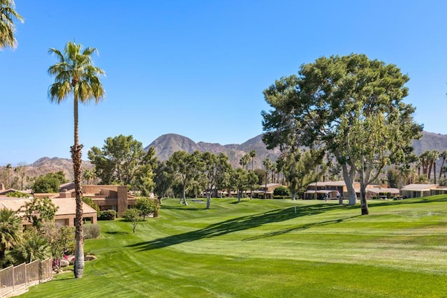 view of community featuring a mountain view and a lawn