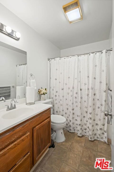 bathroom featuring vanity and toilet