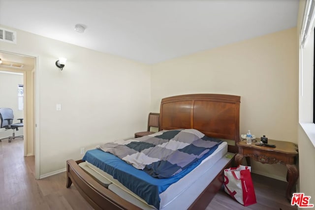 bedroom with hardwood / wood-style floors