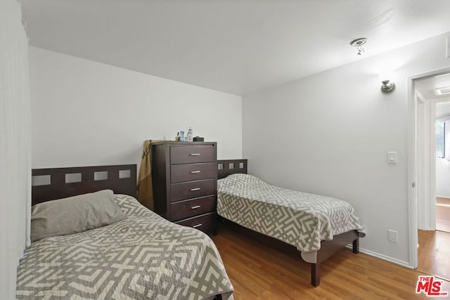 bedroom featuring wood-type flooring