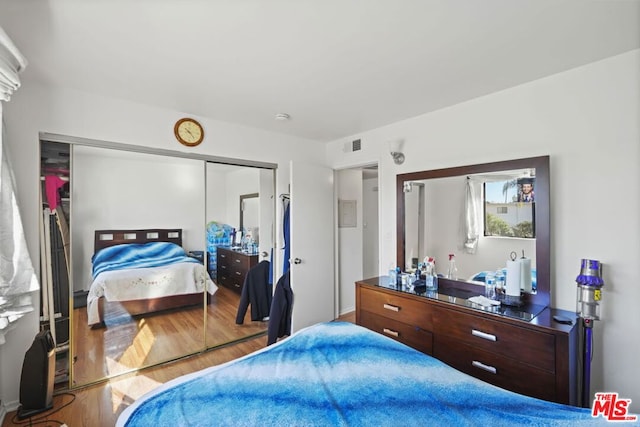 bedroom featuring hardwood / wood-style floors and a closet