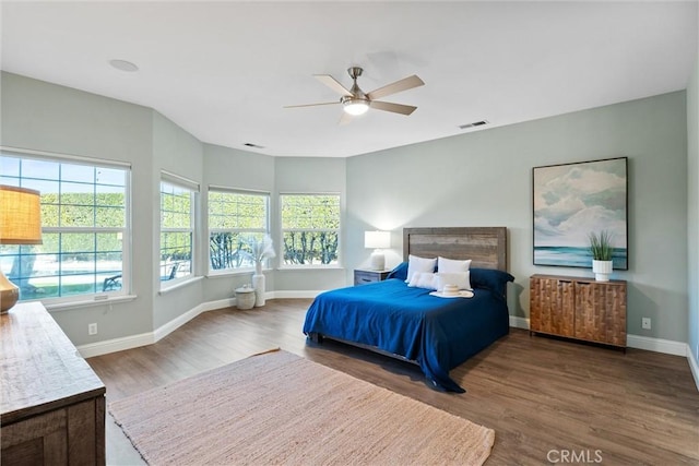 bedroom with dark wood-type flooring and ceiling fan