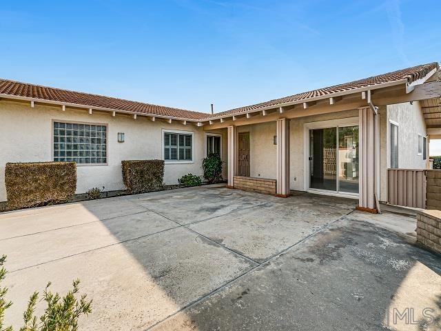 rear view of property featuring a patio area