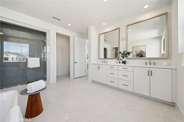 bathroom featuring a shower with door and vanity