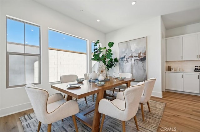 dining room featuring a healthy amount of sunlight and light hardwood / wood-style floors