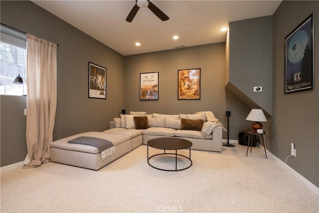 living room with ceiling fan and carpet