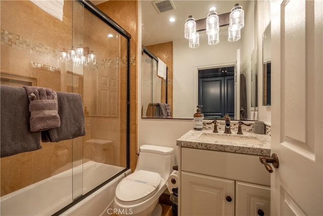 full bathroom with shower / bath combination with glass door, vanity, and toilet