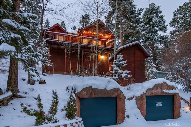 snow covered property featuring a deck