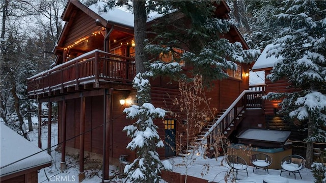 snow covered property with a balcony