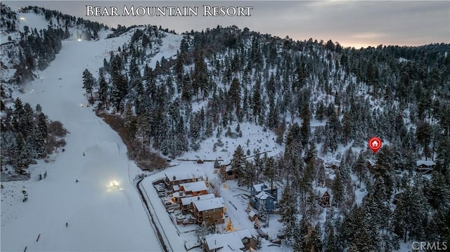 snowy aerial view featuring a mountain view