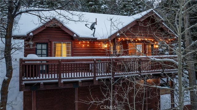 snow covered property with a deck