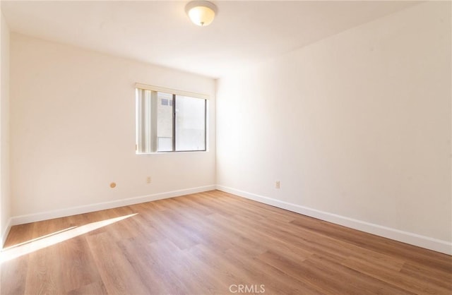 spare room featuring light hardwood / wood-style floors