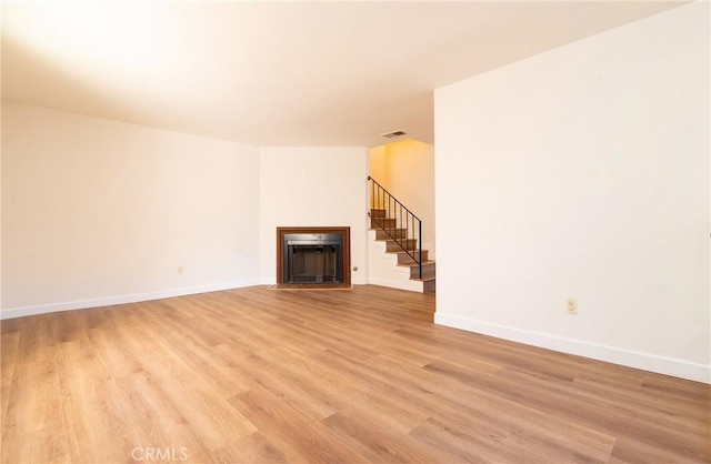 unfurnished living room featuring light wood-type flooring