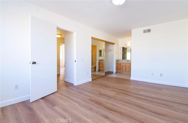 empty room with light hardwood / wood-style flooring