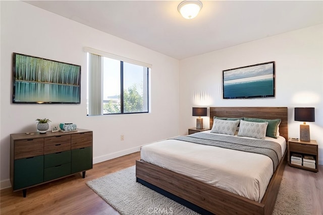 bedroom with hardwood / wood-style floors