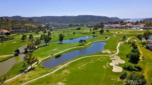 birds eye view of property with a water and mountain view