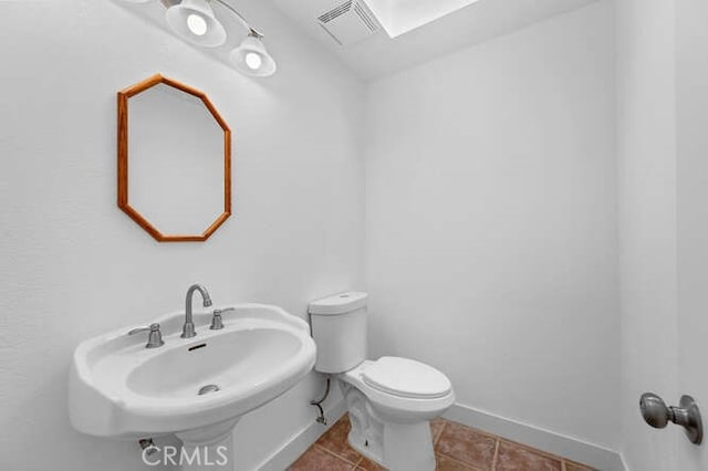 bathroom featuring tile patterned flooring, sink, and toilet