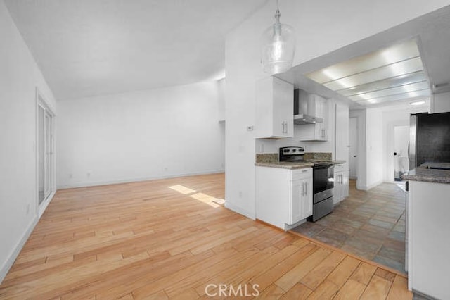 kitchen with white cabinetry, refrigerator, hanging light fixtures, stainless steel electric stove, and wall chimney range hood