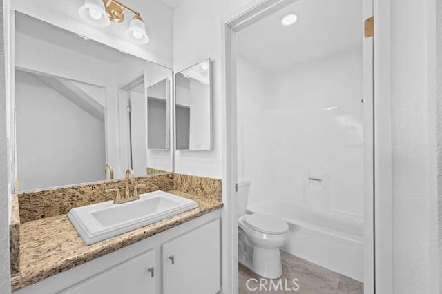 full bathroom featuring vanity, shower / washtub combination, and toilet