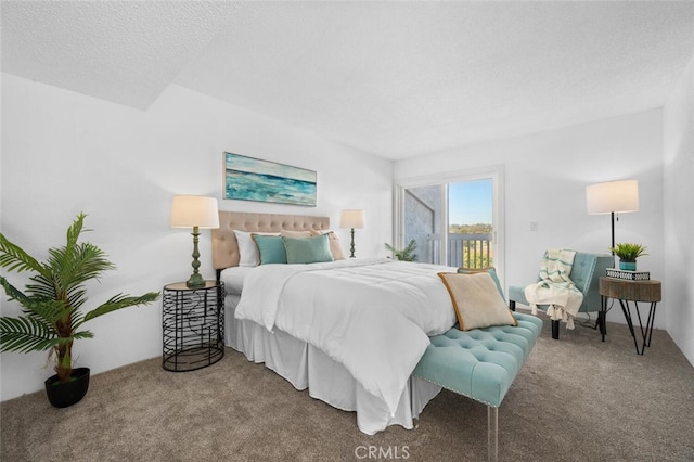 bedroom with a textured ceiling, access to outside, and carpet floors