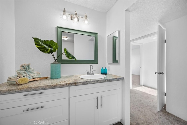 bathroom with vanity and a textured ceiling