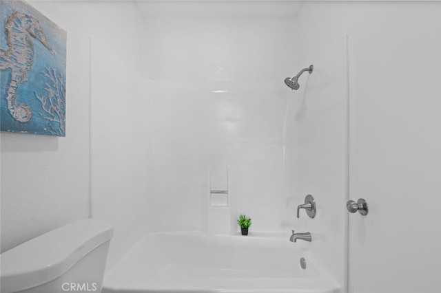 bathroom with toilet and bathtub / shower combination