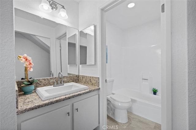 bathroom featuring toilet, shower / bathing tub combination, and vanity