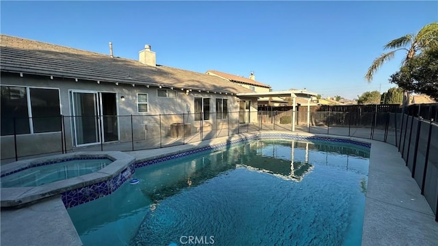 view of pool with a patio and an in ground hot tub