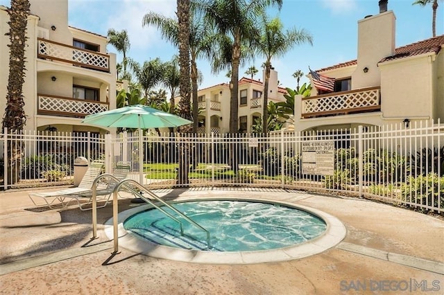 view of pool featuring a hot tub and a patio