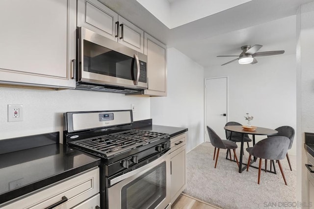 kitchen featuring gray cabinets, appliances with stainless steel finishes, ceiling fan, and light hardwood / wood-style floors