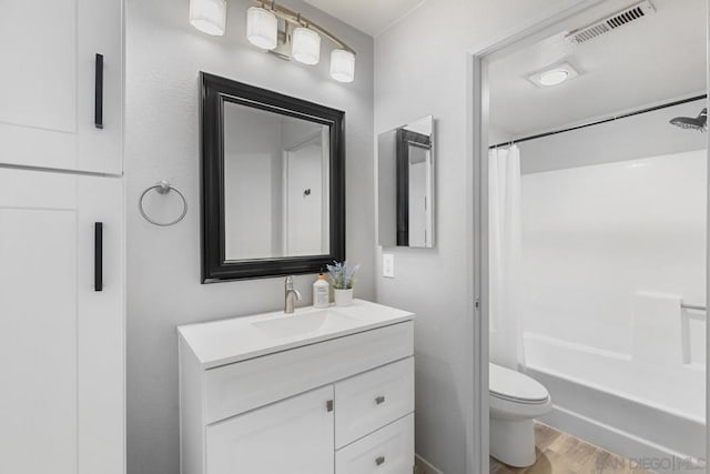 full bathroom featuring vanity, wood-type flooring, toilet, and shower / tub combo with curtain