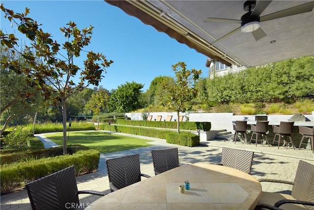 view of patio / terrace with a bar and ceiling fan